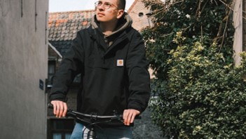 a man on a bike wearing a Carhartt clothing, with the blog title on a blue layer next to him.