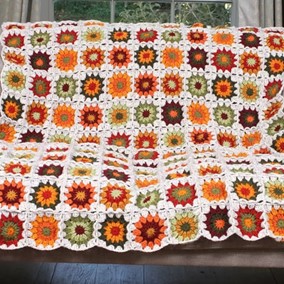 Image of Pachamama Woodstock Throw on a sofa.