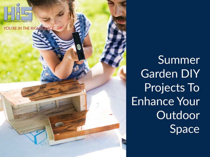 A father and daughter building a birdhouse together in a summer garden