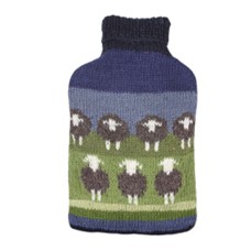 A picture of a hot water bottle with a cover in a sheep pattern